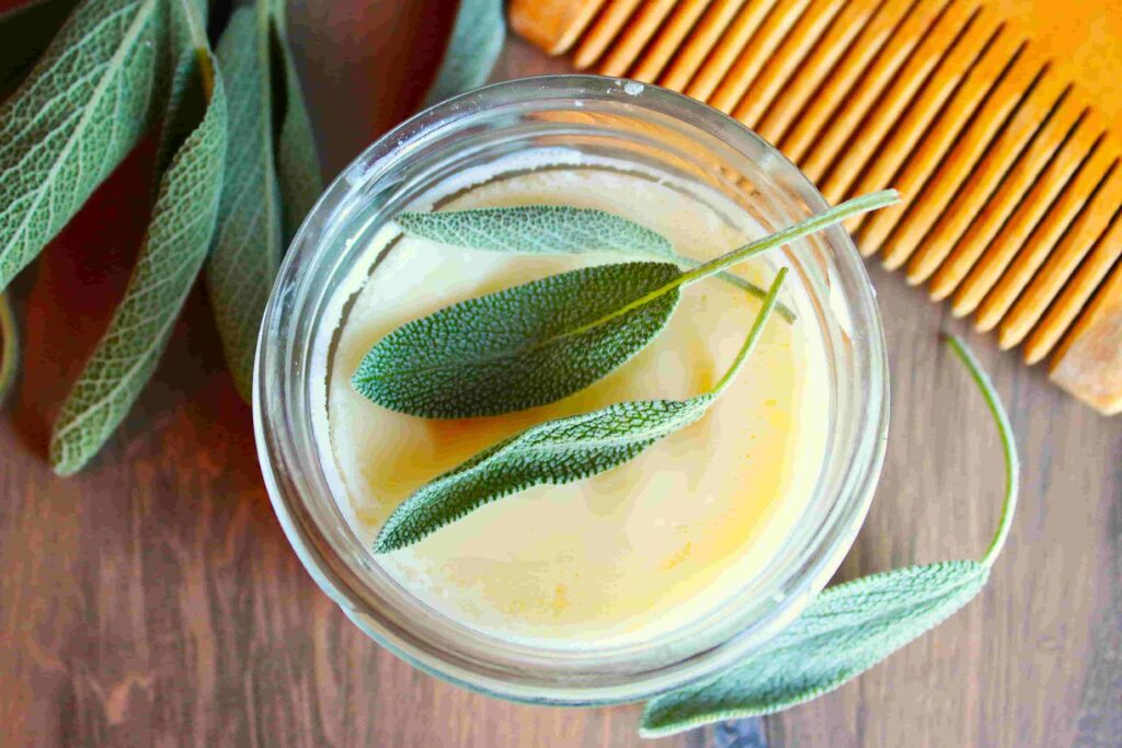 beard butter in glass container with wooden comb and herbs