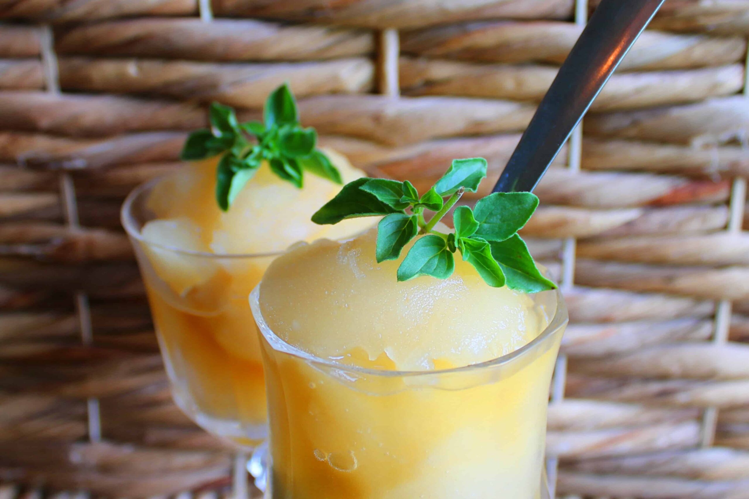traditional Italian lemon sorbet in glasses topped with herbs