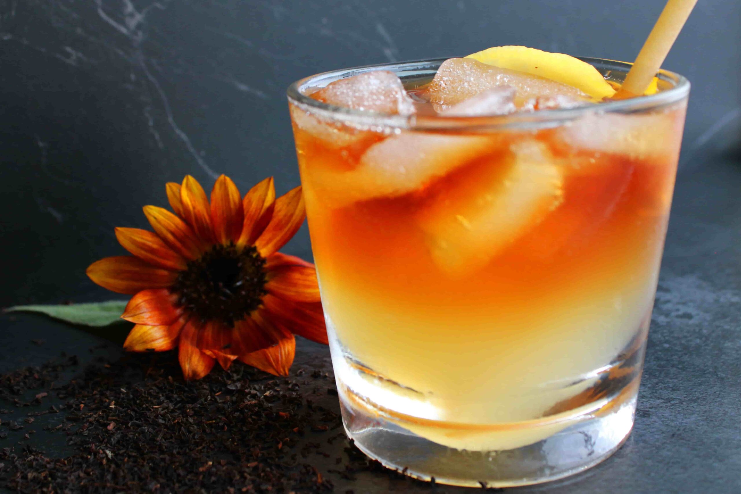 iced black tea lemonade in glass with straw