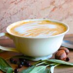 juniper latte recipe in mug with sage and nutmeg