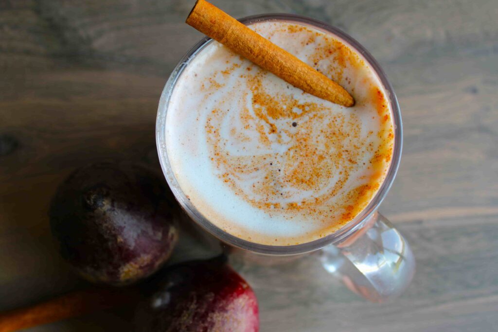 Beet latte in mug with beets on the side birds eye view