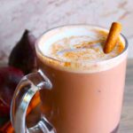 beet latte with coffee in glass mug and cinnamon