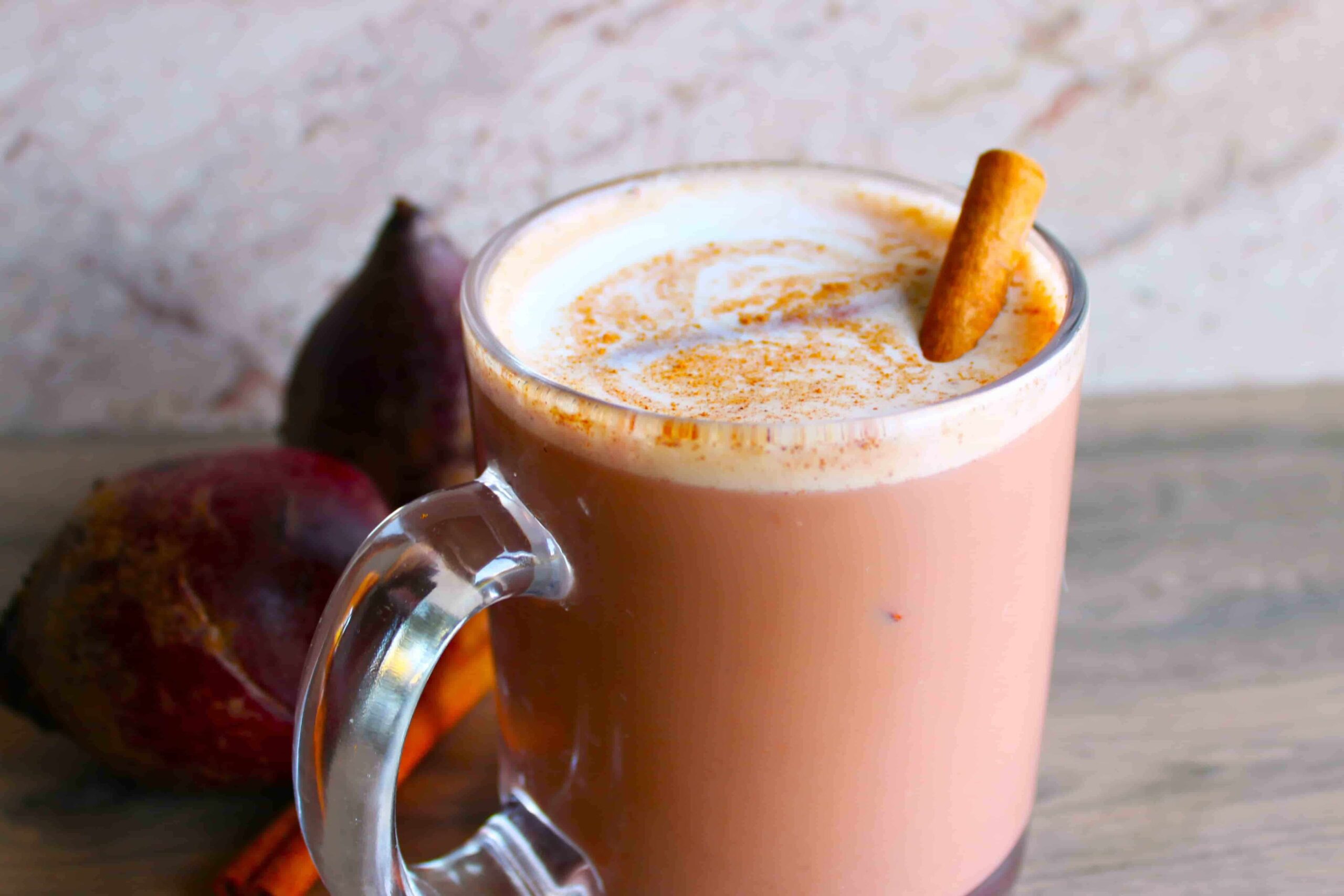 beet latte with coffee in glass mug and cinnamon