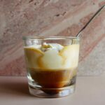 espresso con panna in glass cup with spoon