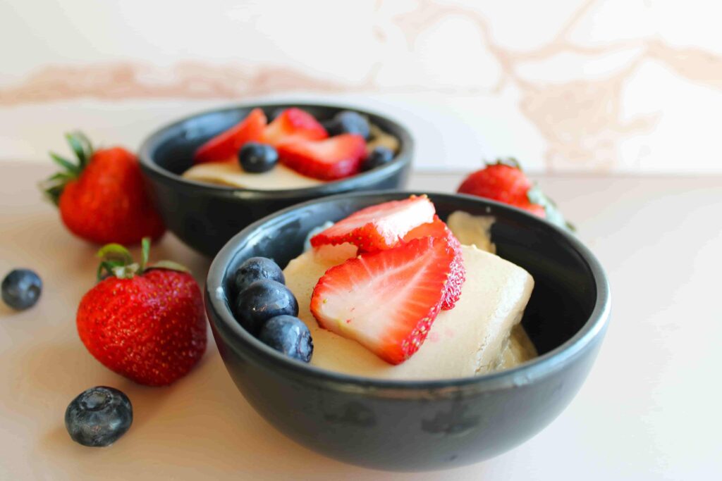 healthy baked Greek yogurt with berries served in black bowls