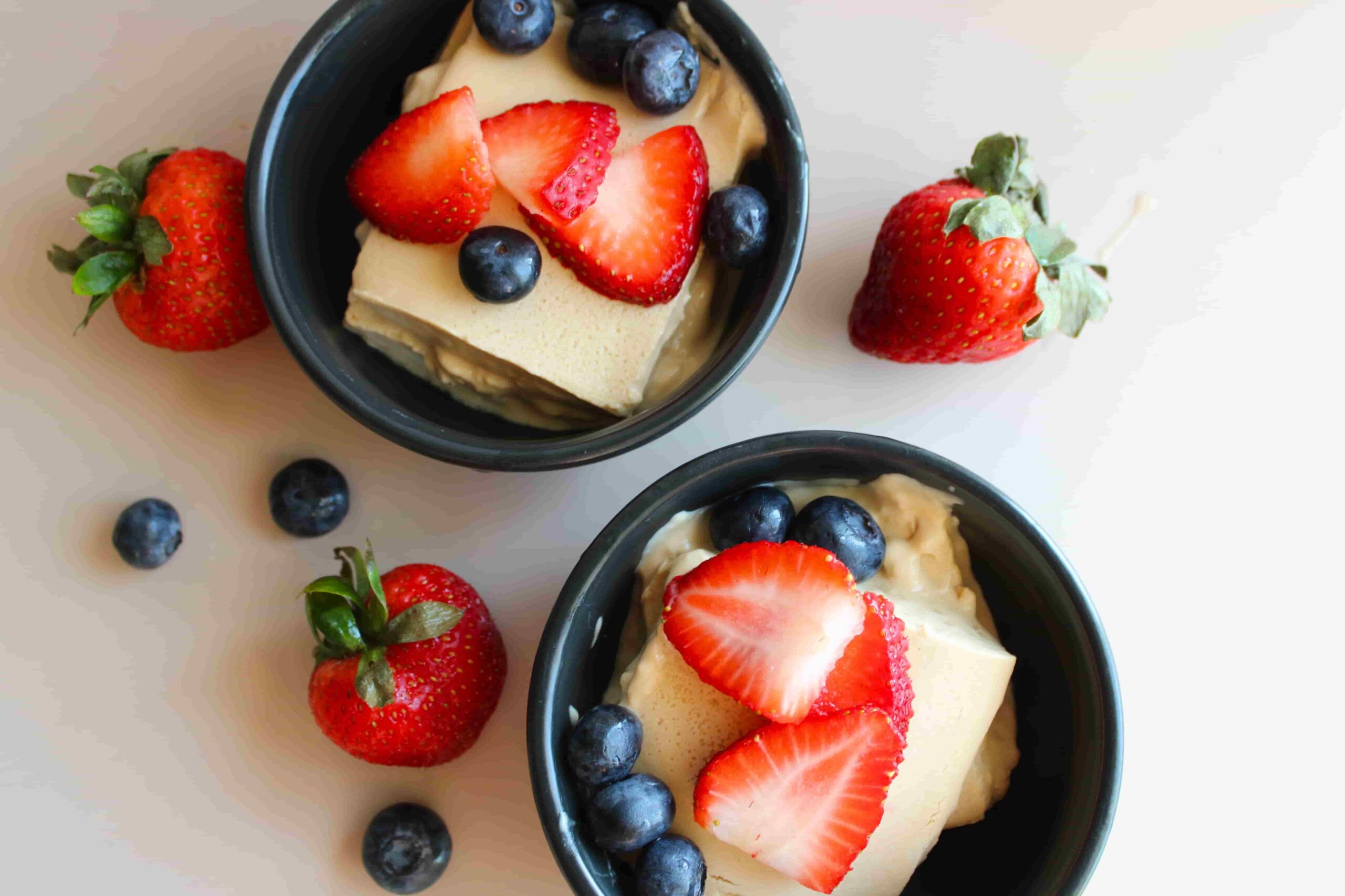 healthy baked yogurt dessert recipe in serving dishes with berries